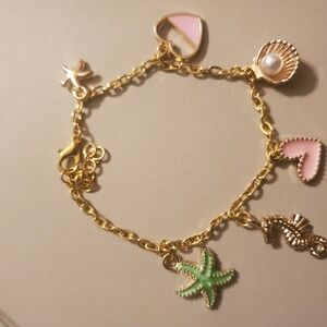 Handmade by my daughter. Gold Charm Bracelet with Pink and Green Accents